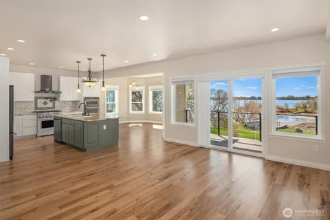 a kitchen with granite countertop stove and a wooden floor