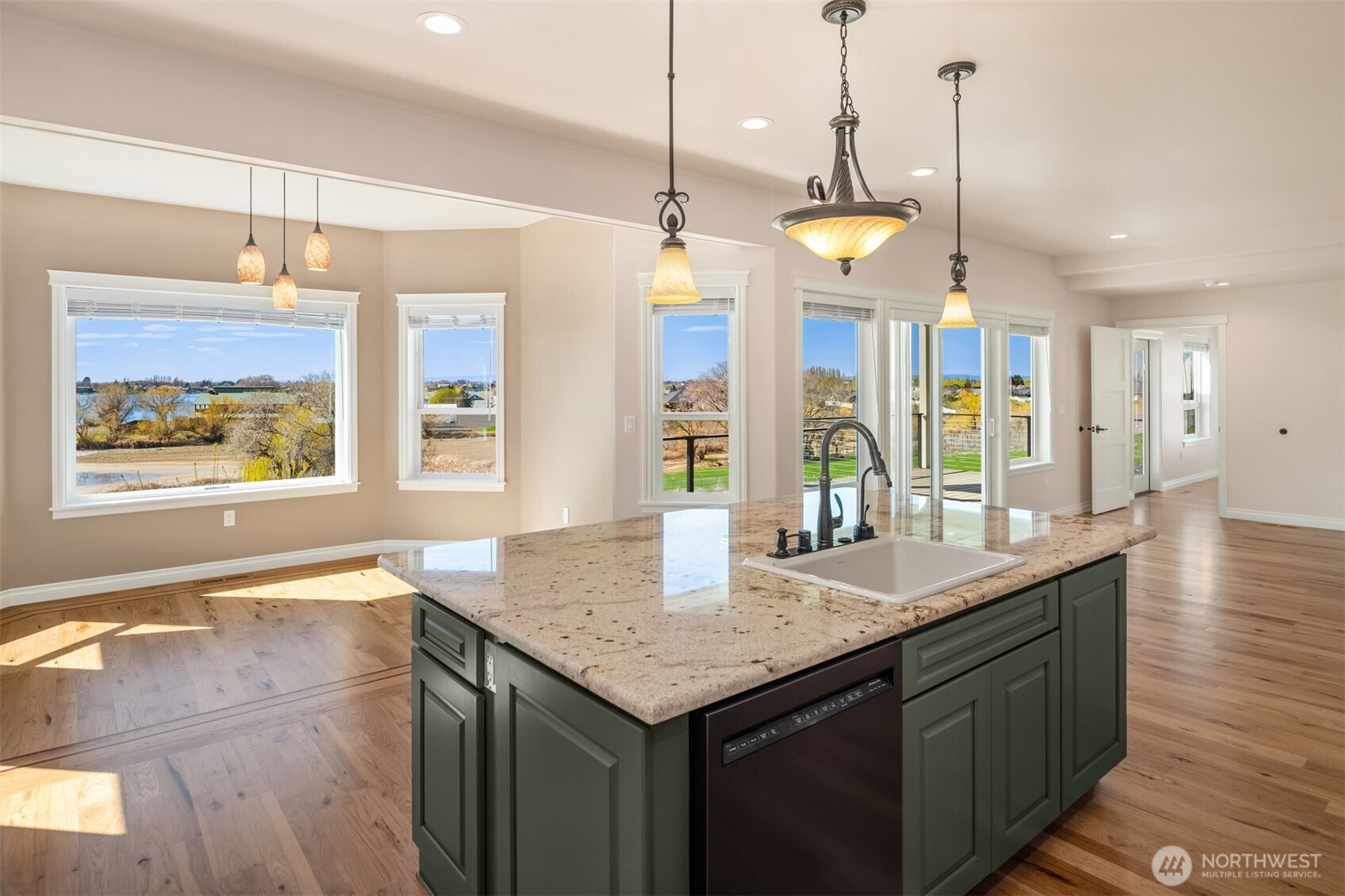 2762 Elgin Road Northeast Moses Lake, WA 98837 - Photo 13 of 37 a kitchen with granite countertop stove and a wooden floor