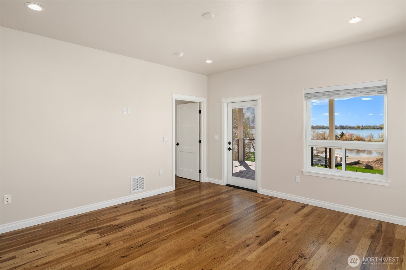 2762 Elgin Road Northeast Moses Lake, WA 98837 - Photo 16 of 37 wooden floor in an empty room with a window
