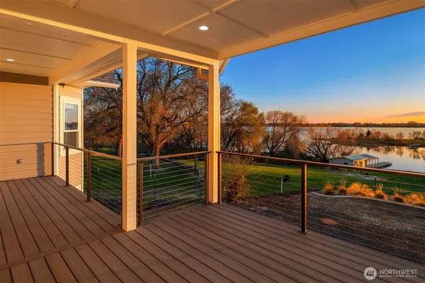 a view of a balcony with wooden floor and city view