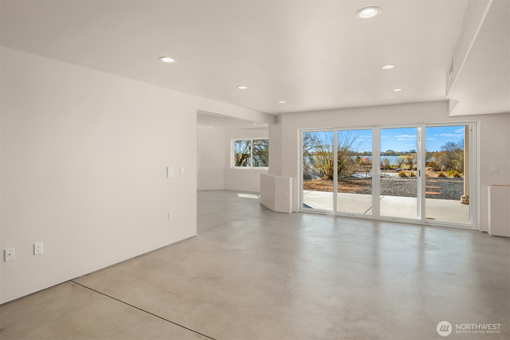 2762 Elgin Road Northeast Moses Lake, WA 98837 - Photo 23 of 37 a view of an empty room with wooden floor and a window
