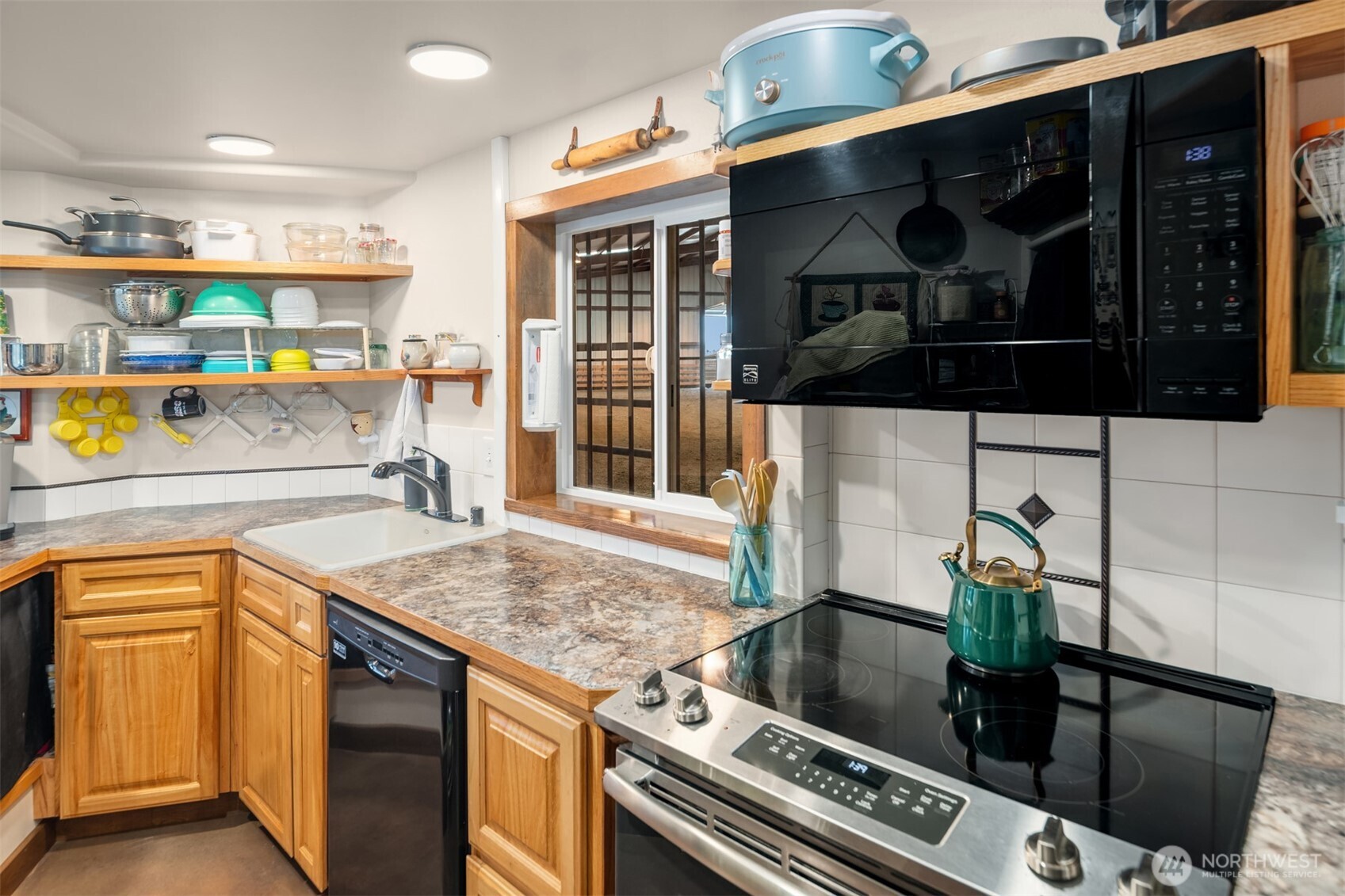 2762 Elgin Road Northeast Moses Lake, WA 98837 - Photo 32 of 37 a kitchen with a sink and cabinets