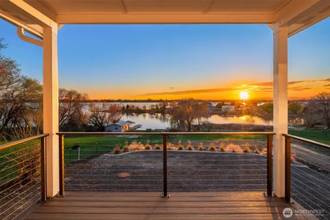 a view of a balcony with wooden floor and fence
