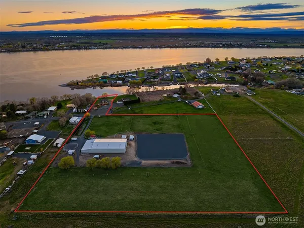 a view of lake with lawn chairs and a yard