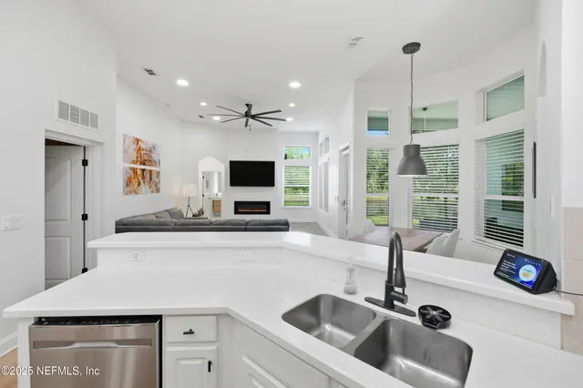 a living room with furniture and a view of kitchen