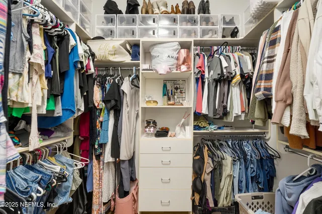 a bathroom with a double vanity sink a mirror and a bathtub