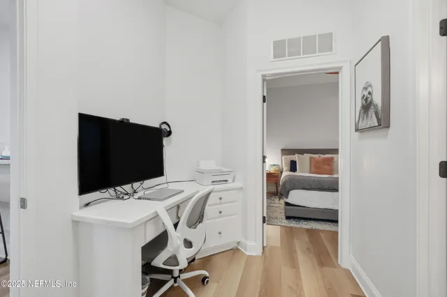 a bedroom with a bed and wooden floor