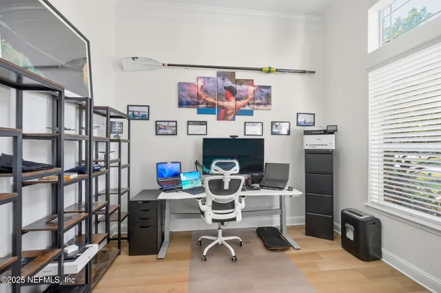 a bedroom with bed and a flat tv screen on dresser
