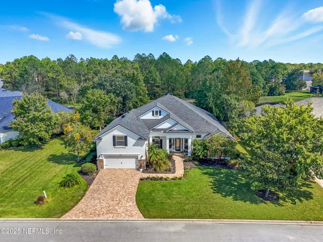 an aerial view of a house with swimming pool and garden space