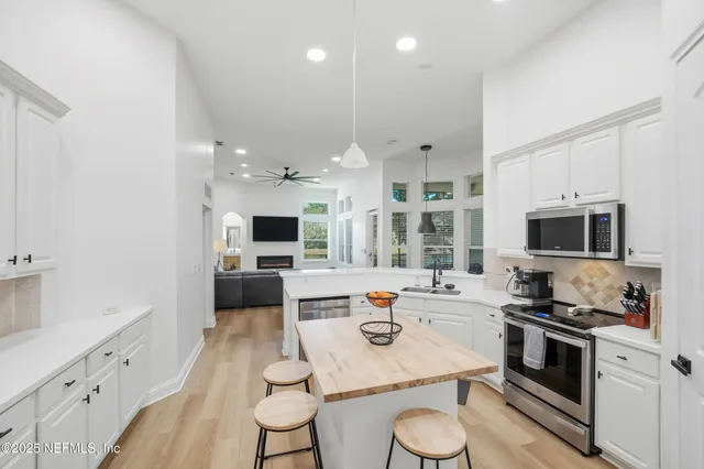 a kitchen with stainless steel appliances kitchen island granite countertop a stove a sink and a microwave