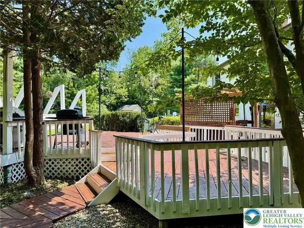 a view of a wooden deck and a backyard