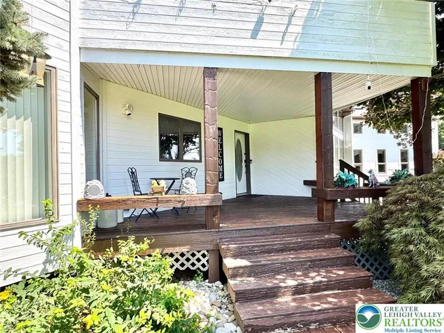 a front view of a house with outdoor seating