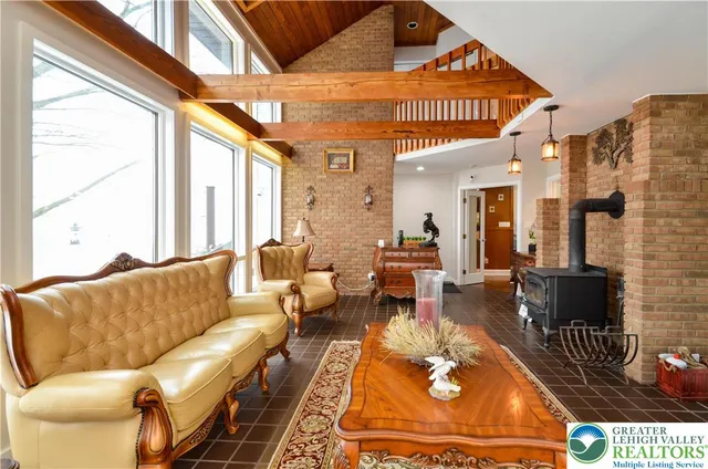 a living room with furniture a rug and a large window