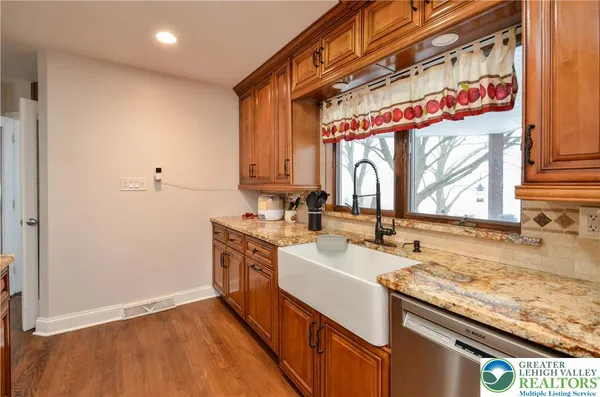 a kitchen with a sink cabinets stainless steel appliances and a counter top space