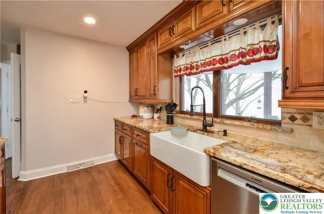 a kitchen with a sink cabinets stainless steel appliances and a counter top space