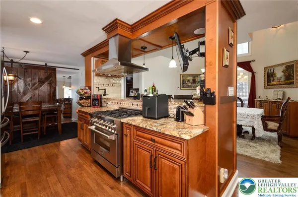 a kitchen with stainless steel appliances granite countertop a stove and a refrigerator