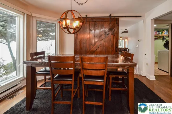 a dining room with furniture and window