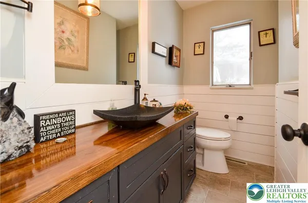 a bathroom with a sink a toilet and mirror
