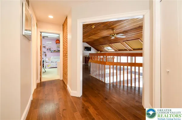 a view of hallway with wooden floor