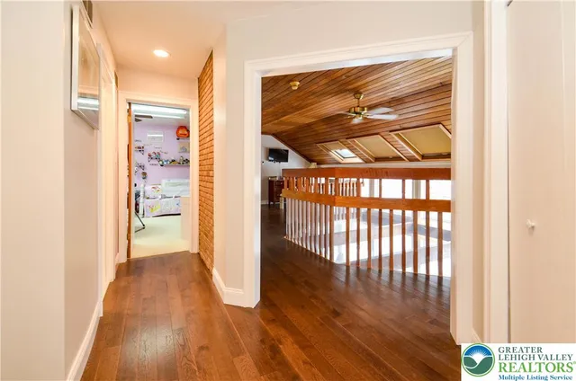 a view of hallway with wooden floor