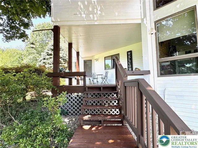 a view of a balcony with a large tree