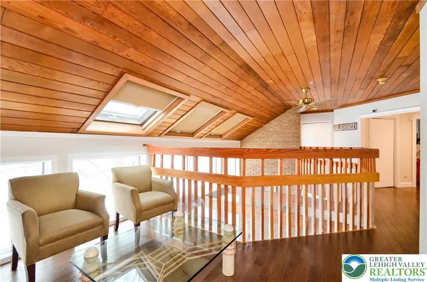 a living room with furniture a flat screen tv and kitchen view