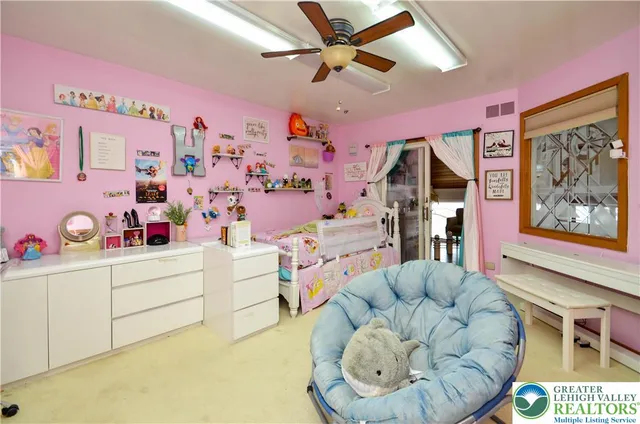 a room with stainless steel appliances kitchen island granite countertop a table chairs and a view of living room