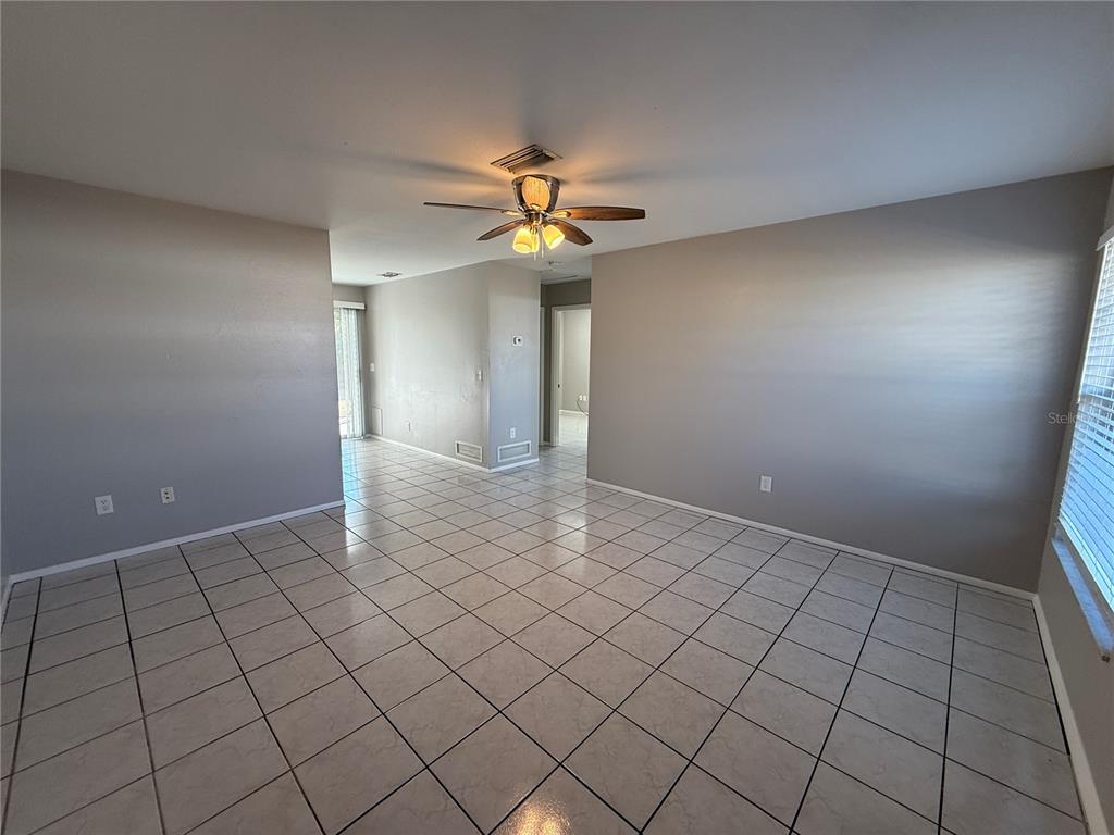 516 Briarwood Road Venice, FL 34293 - Photo 2 of 13 a view of an empty room and chandelier fan