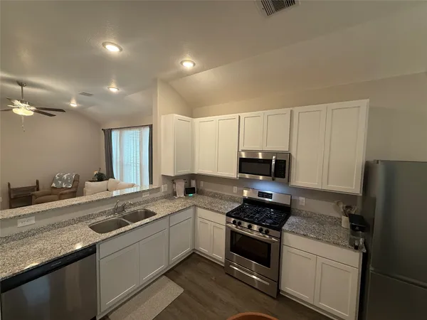 a kitchen with a sink stove and refrigerator