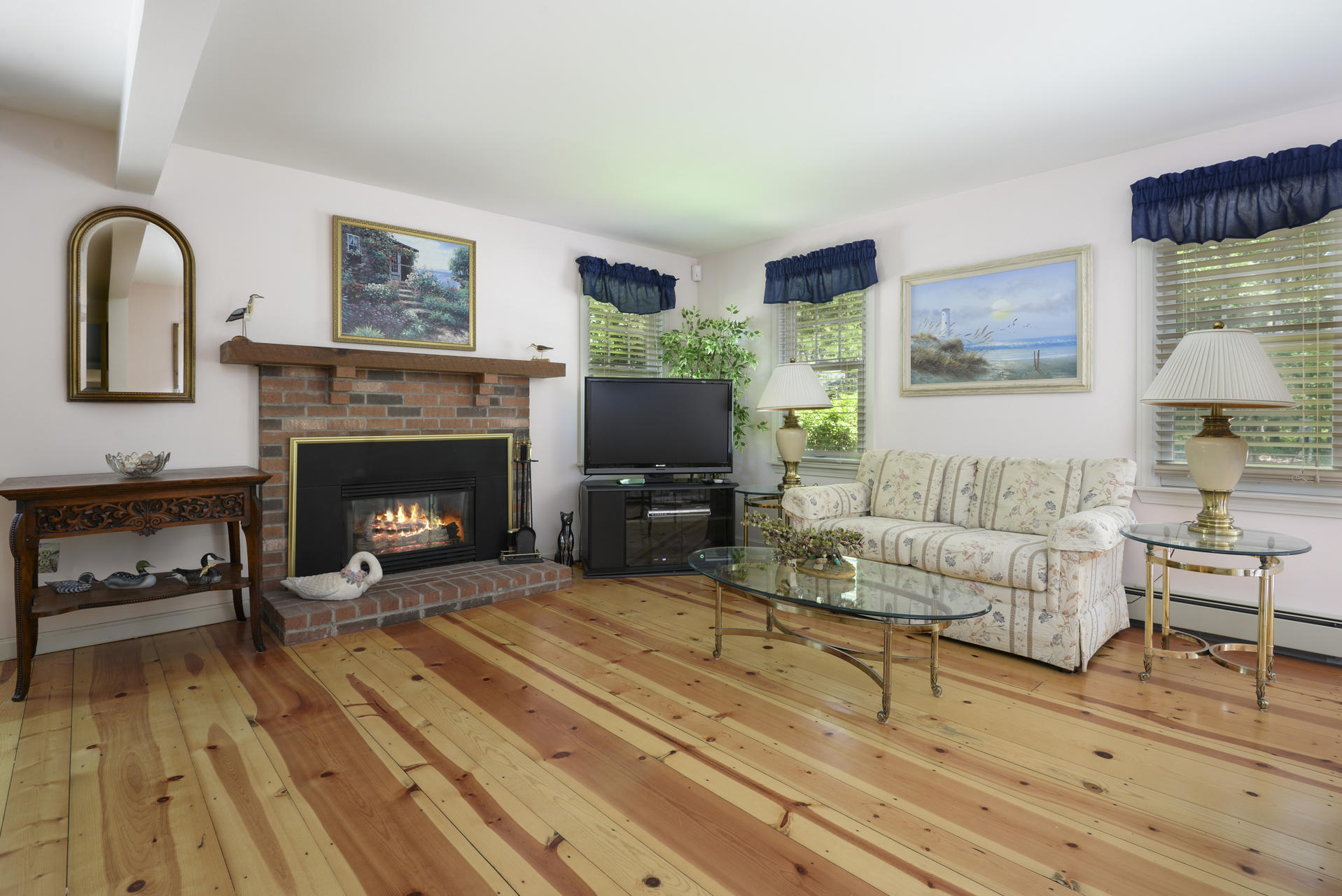 129 Oakwood Road Eastham, MA 02642 - Photo 11 of 30 a living room with furniture and a fireplace
