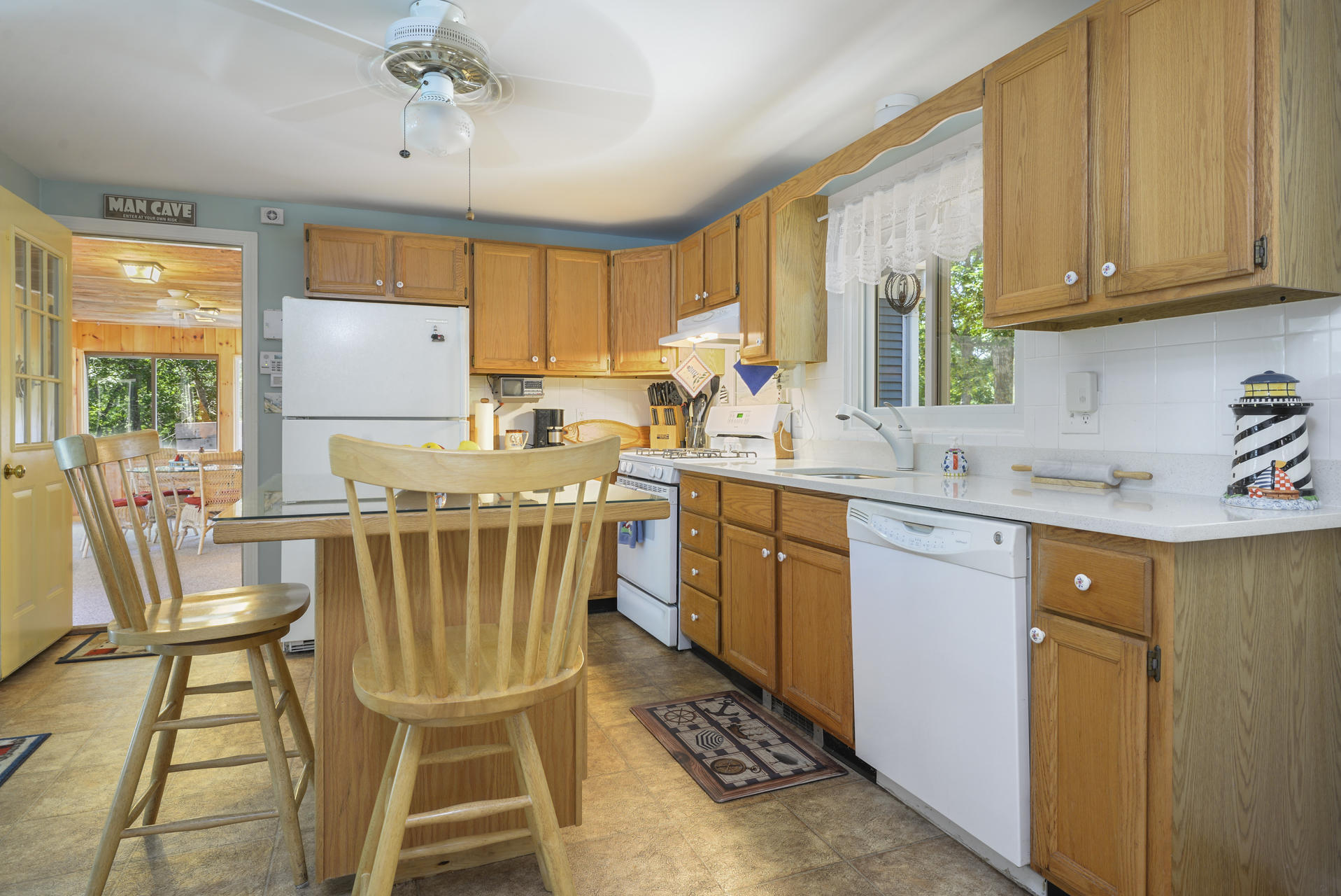 129 Oakwood Road Eastham, MA 02642 - Photo 16 of 30 a kitchen with a sink a stove a refrigerator cabinets and dining table