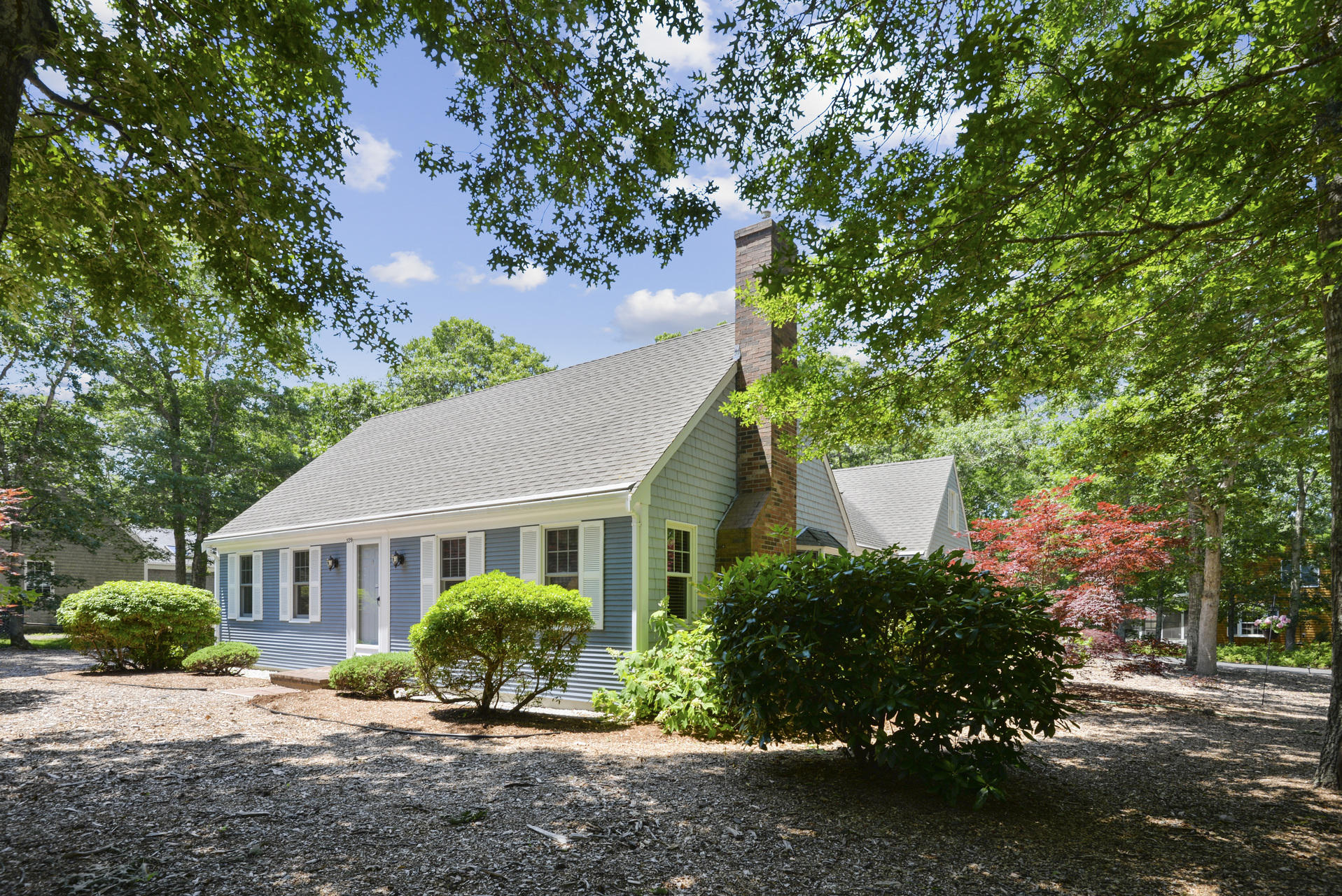 129 Oakwood Road Eastham, MA 02642 - Photo 2 of 30 a view of a house with a yard and plants