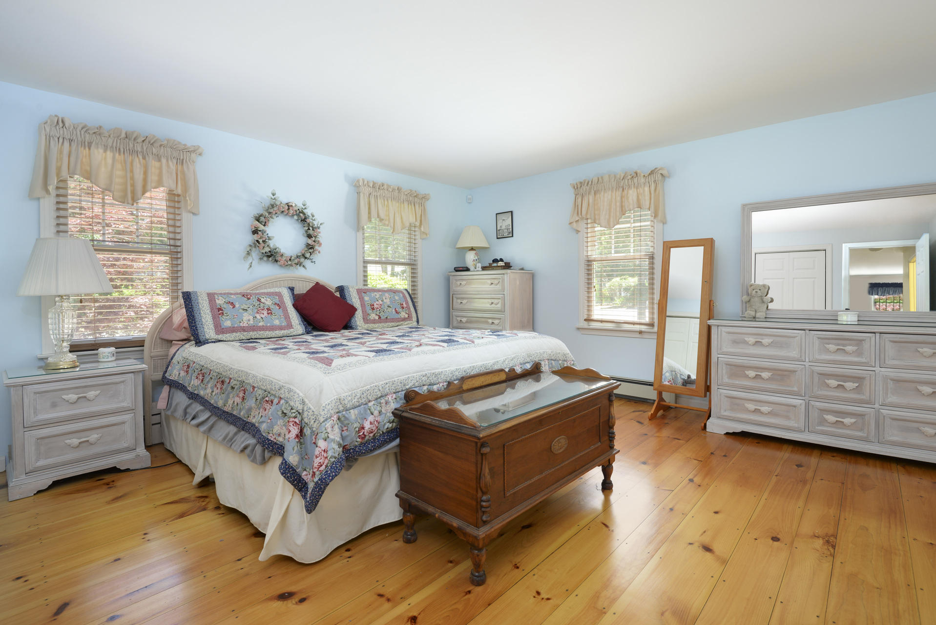 129 Oakwood Road Eastham, MA 02642 - Photo 23 of 30 a bedroom with a bed and wooden floor