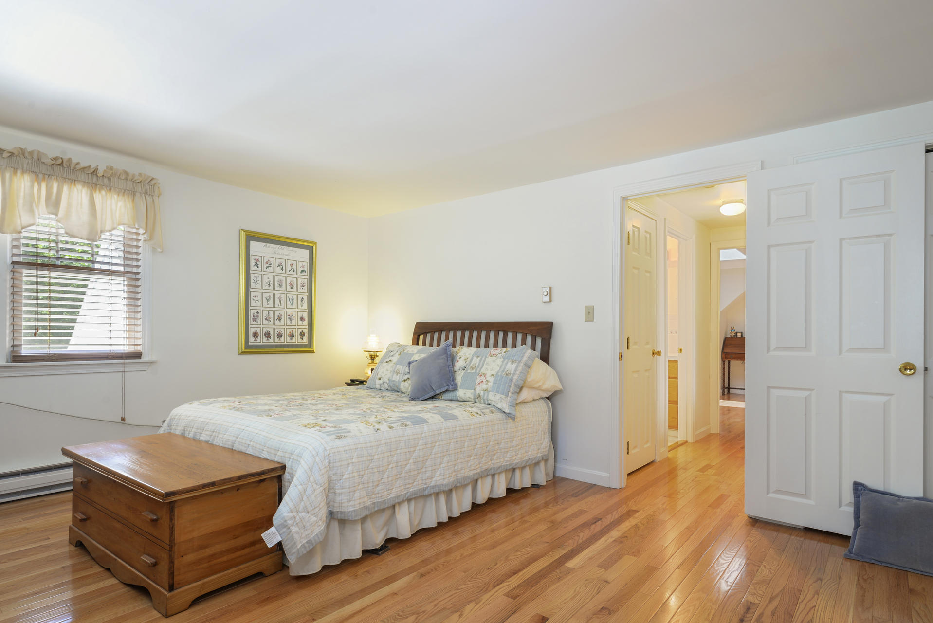 129 Oakwood Road Eastham, MA 02642 - Photo 25 of 30 a bedroom with a bed and wooden floor