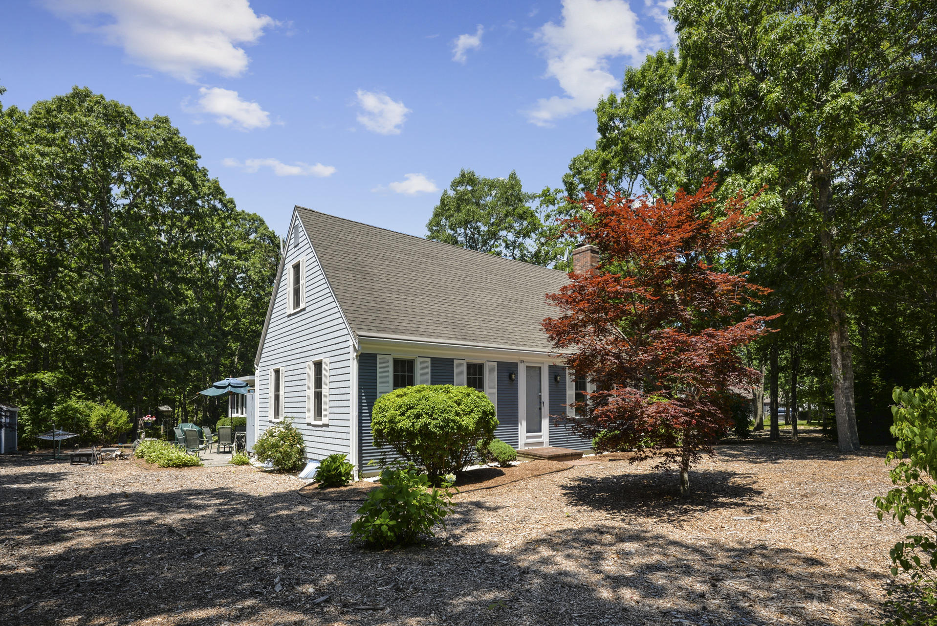 129 Oakwood Road Eastham, MA 02642 - Photo 3 of 30 a view of a house with a patio