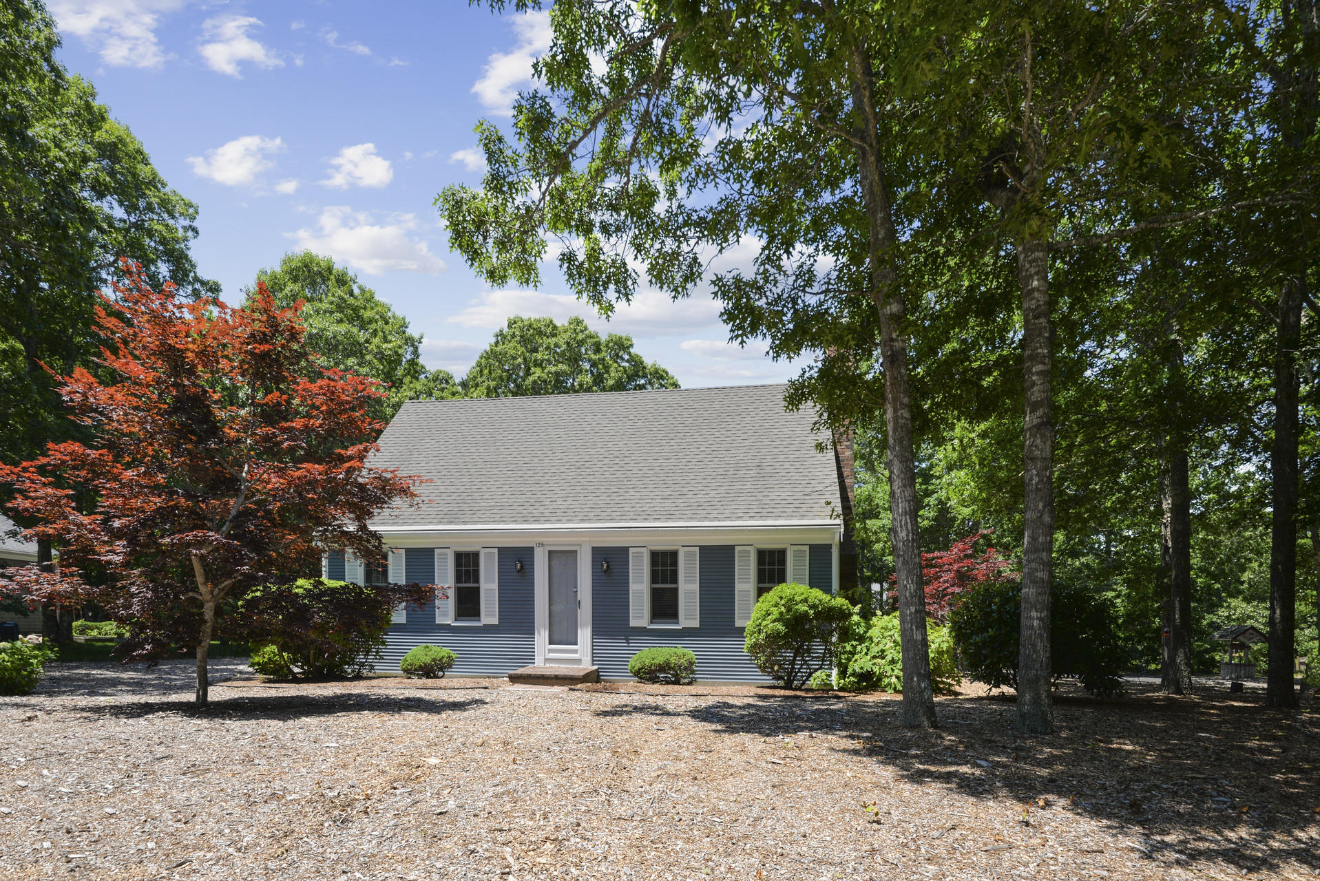 129 Oakwood Road Eastham, MA 02642 - Photo 4 of 30 a front view of a house with a yard