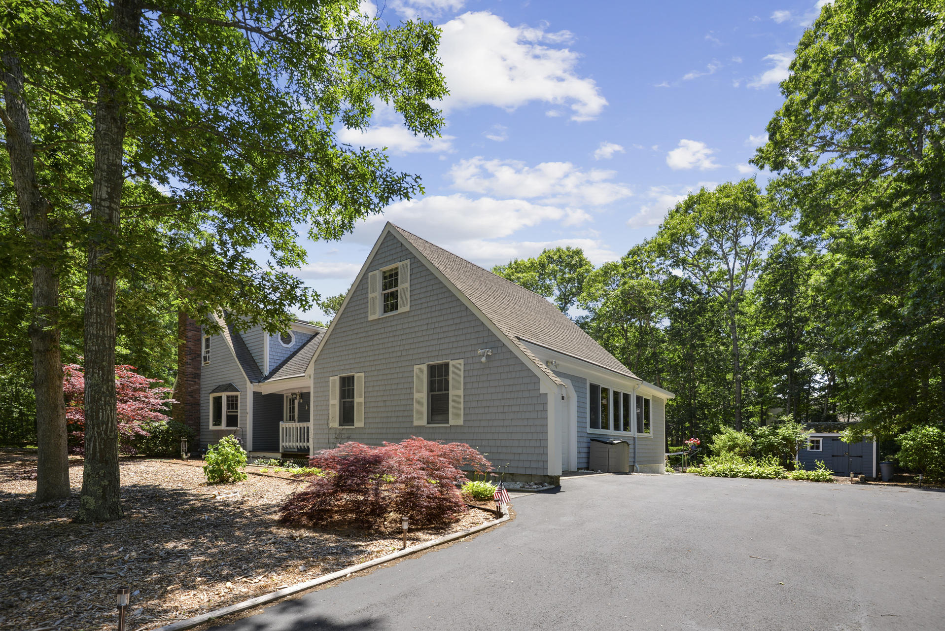 129 Oakwood Road Eastham, MA 02642 - Photo 7 of 30 a front view of a house with a yard and trees