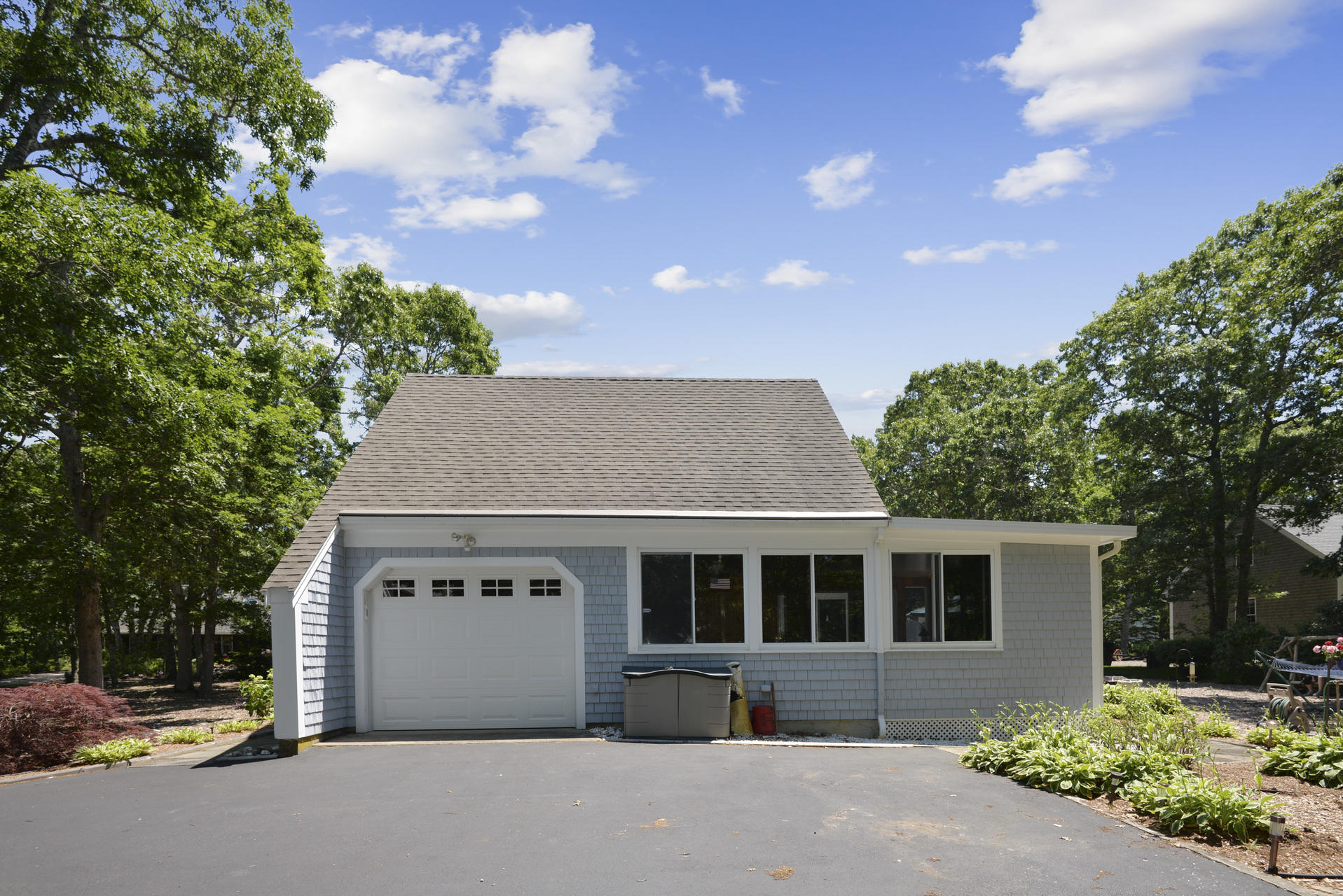 129 Oakwood Road Eastham, MA 02642 - Photo 8 of 30 a front view of a house with a garden