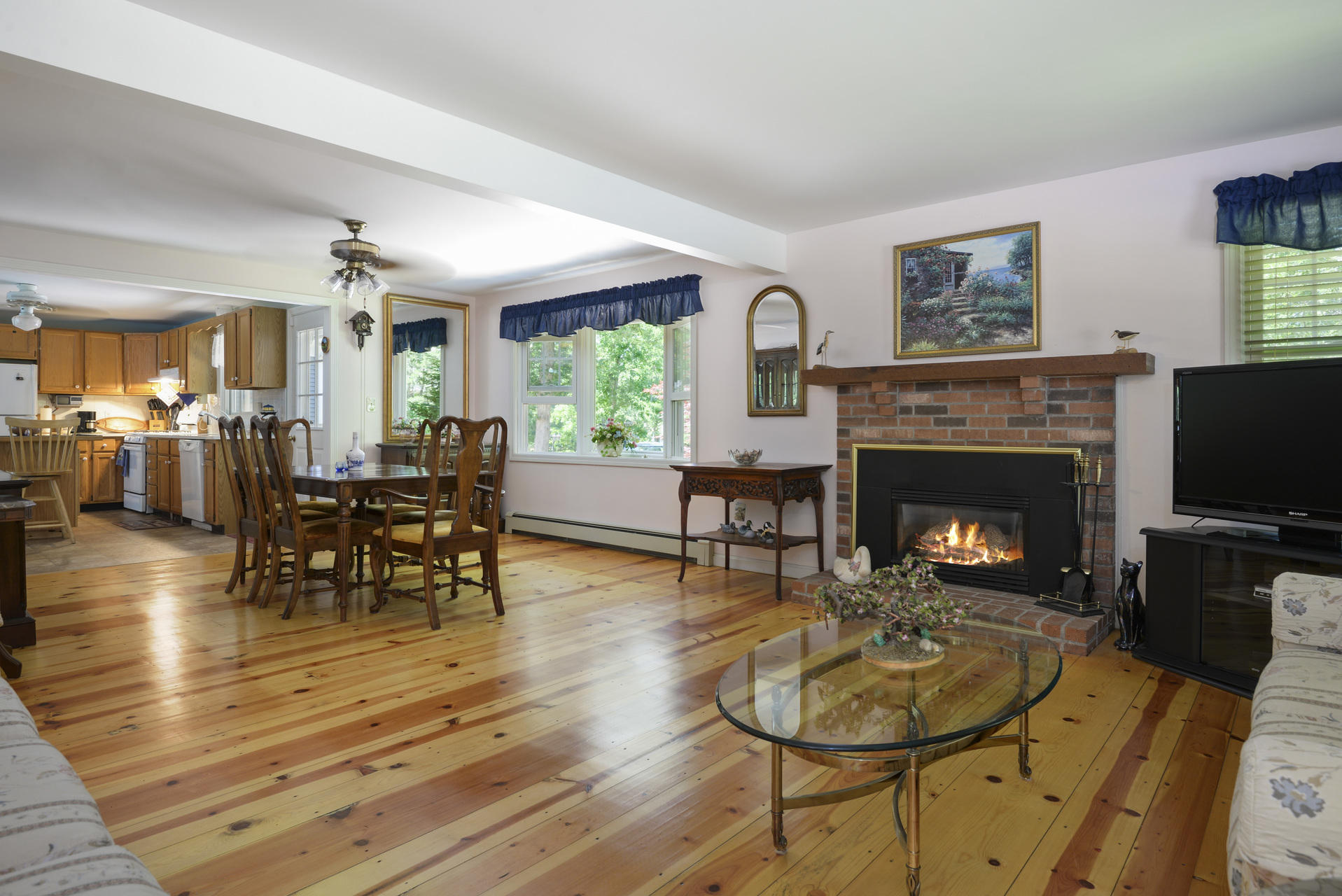 129 Oakwood Road Eastham, MA 02642 - Photo 10 of 30 a living room with furniture a fireplace and a flat screen tv