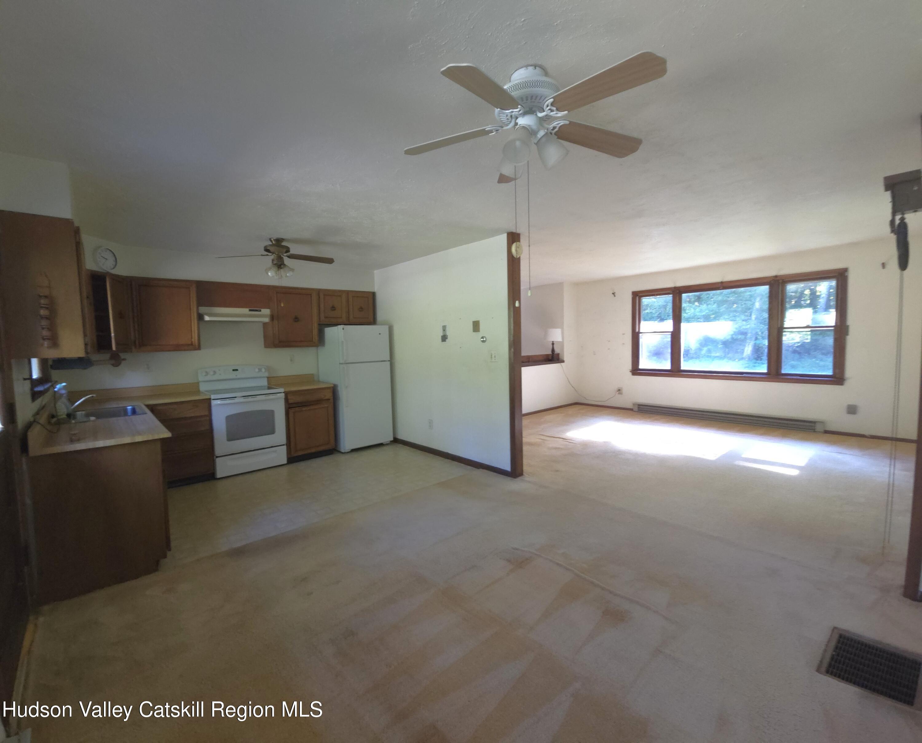 46 Cone Place Leeds, NY 12451 - Photo 5 of 20 a view of a kitchen with a sink a ceiling fan and windows