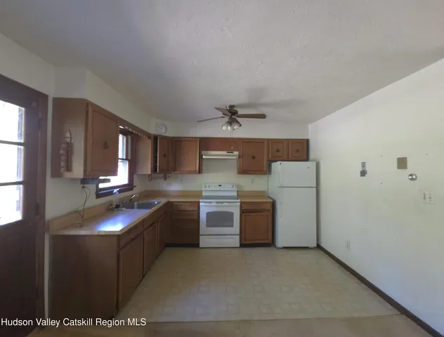 a kitchen with sink cabinets and stove