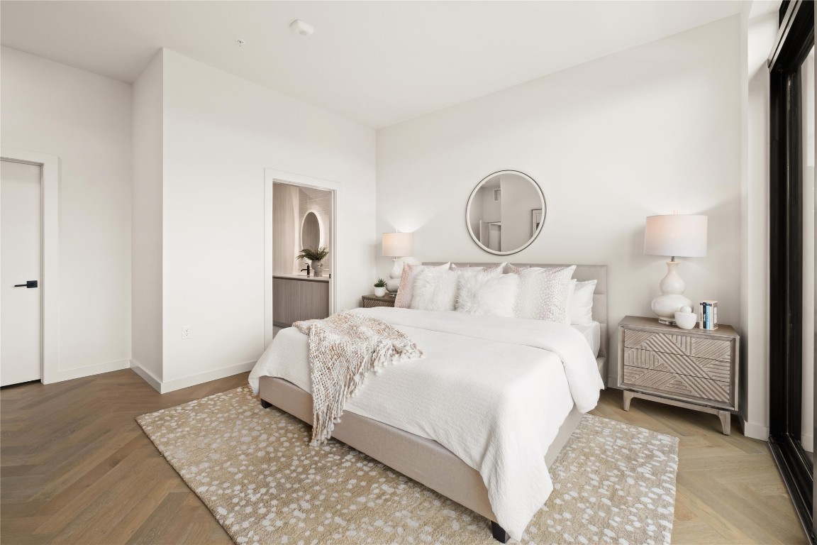2209 South 1st Street, Unit 403 Austin, TX 78704 - Photo 11 of 40 a bedroom with a bed and wooden floor
