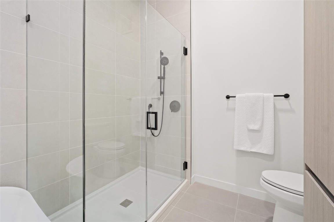 2209 South 1st Street, Unit 403 Austin, TX 78704 - Photo 13 of 40 a bathroom with a shower and toilet