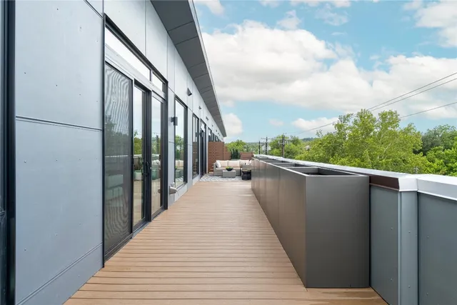 a view of balcony with wooden floor and fence