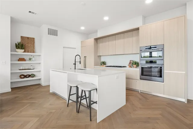 a kitchen with a sink cabinets and stainless steel appliances