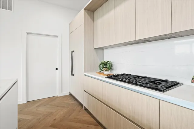 a kitchen with granite countertop a sink and cabinets