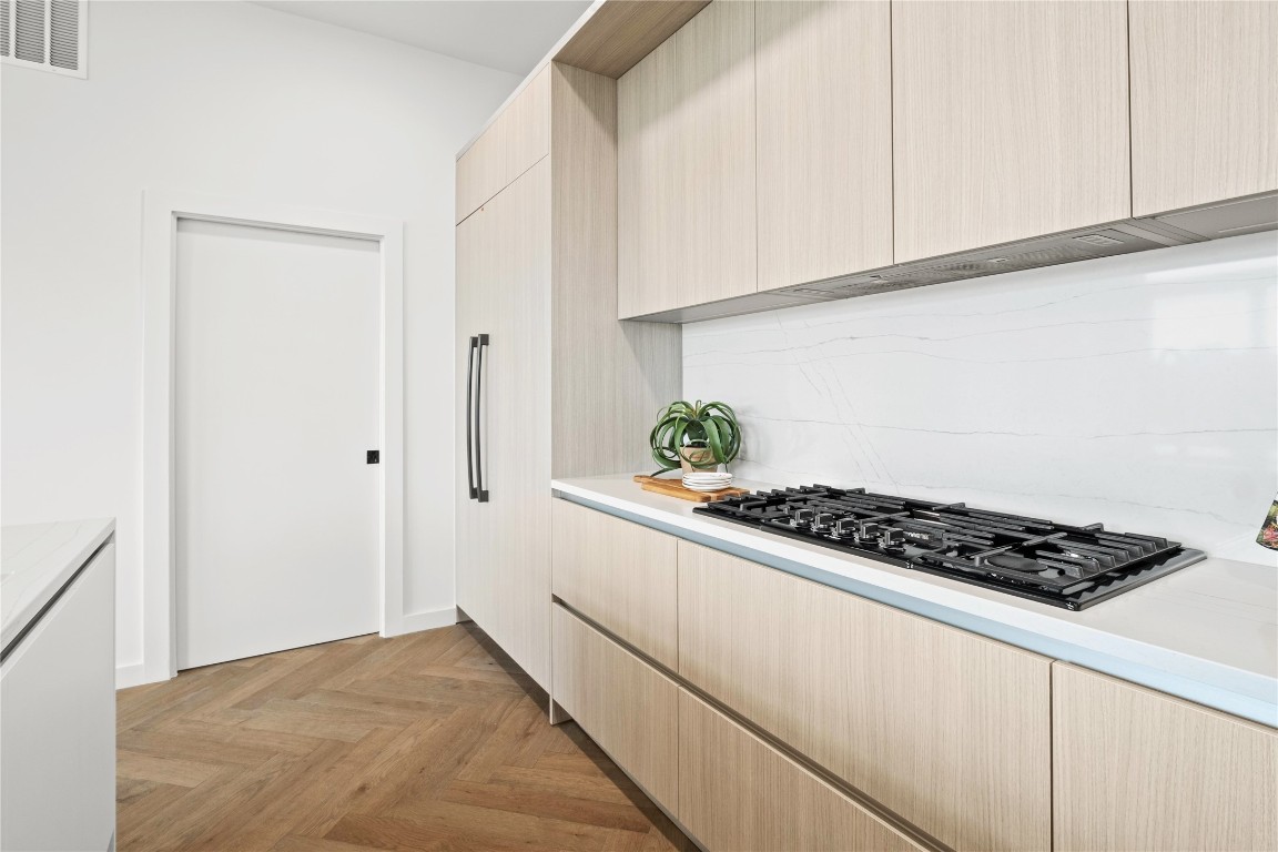 2209 South 1st Street, Unit 403 Austin, TX 78704 - Photo 7 of 40 a kitchen with white cabinets and a stove