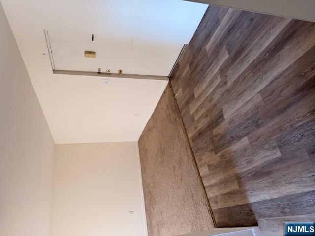 a view of a room with wooden floor