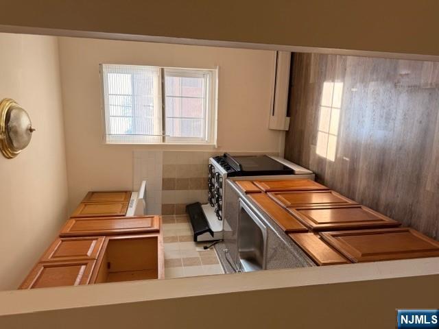 278 Main Street, Unit F6 Little Ferry, NJ 07643 - Photo 2 of 7 a kitchen with stainless steel appliances granite countertop a stove a sink and a refrigerator