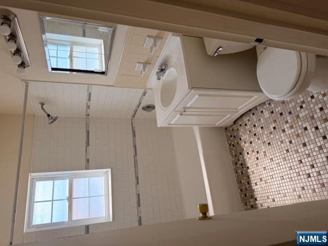 278 Main Street, Unit F6 Little Ferry, NJ 07643 - Photo 4 of 7 a bathroom with a sink a toilet and shower